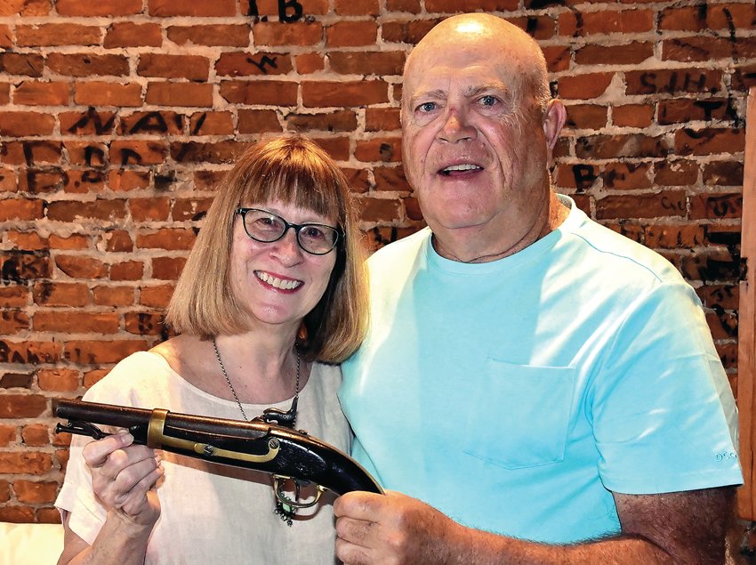 Jim and Suzanne Sproule stand with their one-in-a-million find, a Civil War pistol owned by Suzanne&rsquo;s great-grandfather, John Rodden.