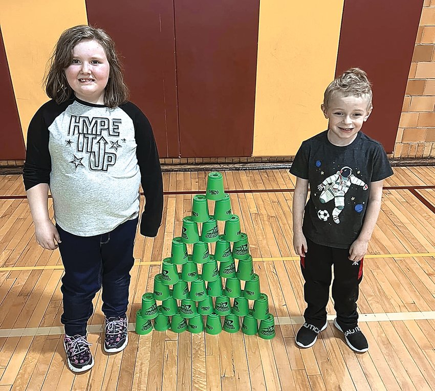 Students in Kindergarten through second grade at Stockton Elementary School worked on speed stacking in their physical education class. Students learned the basic 3 stack, the 3-3-3 stack, 3-6-3 stack and the 6-6 stack. Cup stacking helps the elementary students use both sides of their bodies and brains to develop important skills and also promotes hand-eye coordination, ambidexterity, quickness and concentration. Students Emma Raab and Thomas Morgan show off their stacking abilities.