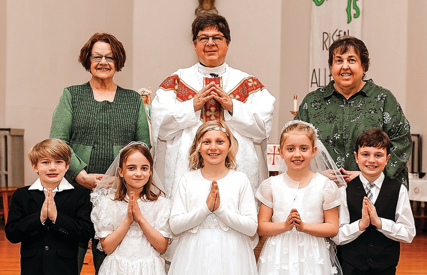 First Communion was celebrated at St. Joseph Parish, Sinsinawa, on Sunday, May 1. Father Peter Auer officiated the 8:30 a.m. Mass. Pictured are, back row from left: Dr. Becky Lee, teacher; Rev. Peter Auer; and Barbara Wills, principal; Front row: Fitzgerald Runde, Arabella Leibfried, Lillie Eastlick, Celia Berning and Harrison Koltes.