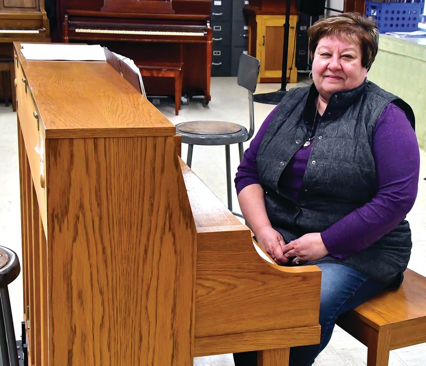 Stockton music teacher Lana Crandall sits by the piano in her music classroom earlier this school year. Crandall is retiring from teaching after 23 years, 17 of those at Stockton, her alma mater.