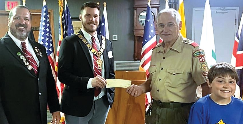 The Galena Elks Club has donated $1,000 to Galena Boy Scout Troop 95 and Cub Scout Pack 93 with Gratitude Funds from the Elks National Foundation. From left, Brian Kelly, the lodge&rsquo;s national foundation chair, and Exalted Ruler Tyler Long present a check to Don Kern and Cub Scout Jason Kelly.
