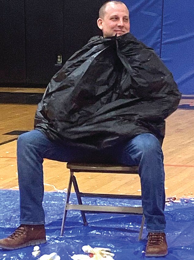 Dr. Shawn Teske awaits a pie as one of the winners of the pie war held at Warren School District to raise money for Hearts and Hands for Hunger. Warren&rsquo;s servant leadership team led the efforts which raised over $850 for the organization.