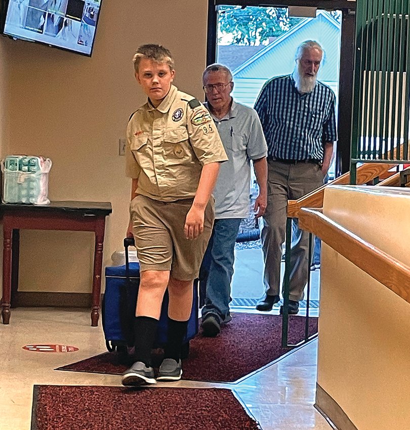 Boy Scout Nolan LuGrain, Galena, wheels in election results from Rawlins Township on June 28 following the primary election.