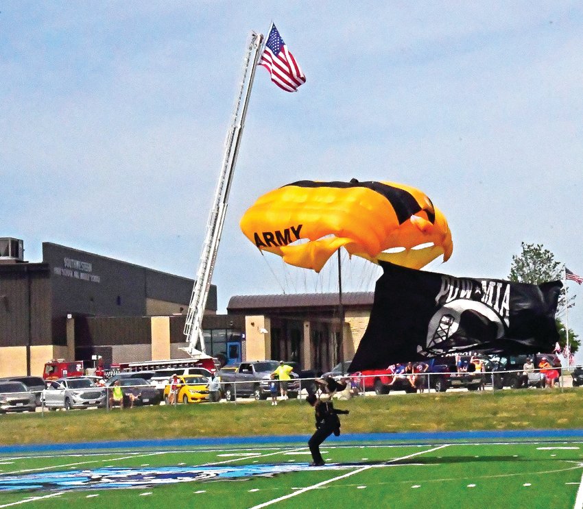 A member of the United States Army Golden Knights Parachute Team sticks his landing on the Wildcat logo on Saturday, July 2.