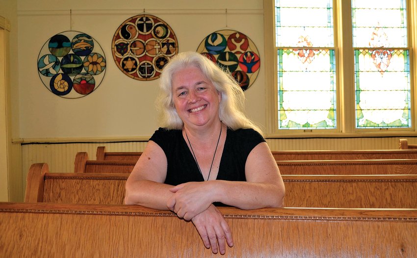 The Rev. Dr. Michele Townsend Grove relaxes in the pews of the Unitarian Universalist Church of Stockton, 219 N. Pearl Street, where she is the new pastor.