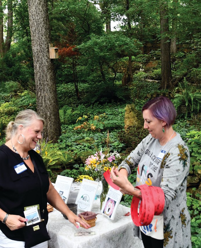 Just-right weather greeted the Galena Center for the Arts supporters during the annual Garden Party fundraiser at LinMar Gardens on Sunday, Aug. 21. Here, Irene Thraen-Borowski provides raffle tickets for the various experiences available, such as scrapbooking, scone-making, or learning a magic trick.