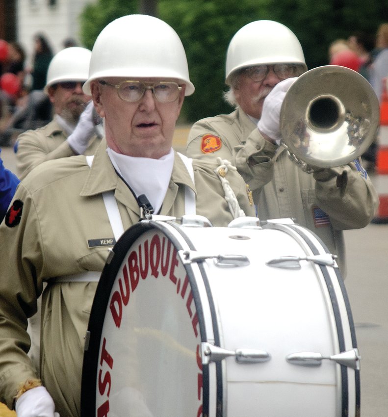 Bill Kemp plays the bass drum as the East Dubuque Drum &amp; Bugle Corps marched in the 2015 East Dubuque Memorial Day Parade. Playing a horn in the background is Dave Oglesby, Dubuque, Iowa.