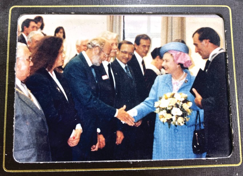 Robert Scott shakes hands with Queen Elizabeth II at a dedication ceremony at Clitheroe Royal Grammar School in Lancashire, England on Oct. 18, 1990. He is the father of Julie Soat, Galena.