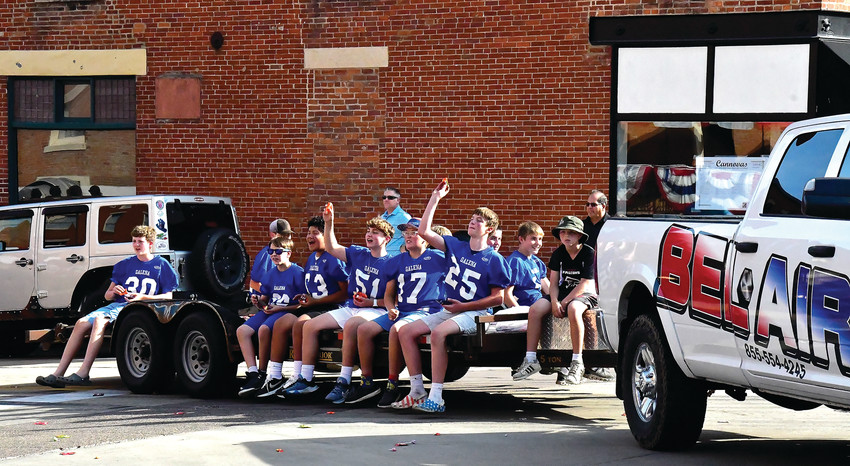Andrew Richardson, Peter Wagner, Gael Cabanas, Haadi Khatib, Ian Faulkner, Jack Duggan, Keinan Lyden and other members of the eighth grade football team threw candy out into the crowd during the parade.