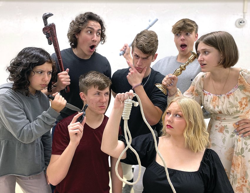 Cast members of Galena High School&rsquo;s production of Clue display the famous murder weapons from the board game of the same name as they rehearse a scene from the comedy. Cast members, clockwise, from left, are Liliana Asta, Hayes Noble, Cael Ozee, Charlie Duncan, Ella Getz, Emma Blaum, and Conner Soat.