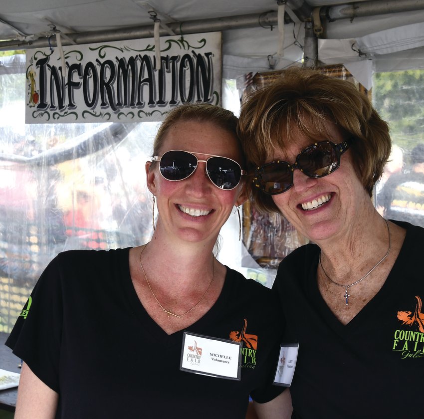 Michelle Murdock and Libby Miller served as volunteers at last year&rsquo;s Galena Country Fair. The annual fair that draws thousands of visitors to Galena is this weekend at Grant Park.