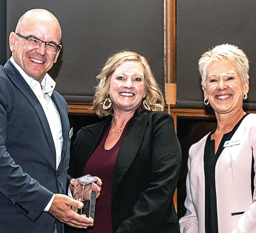 Joe Mattingley, NWILED Vice Chair, and Chris Kuberski, NWILED board member, right, present the NWILED Partner of the Year Award to Kim Ewoldsen, from the Small Business Development Center at Sauk Valley Community College.
