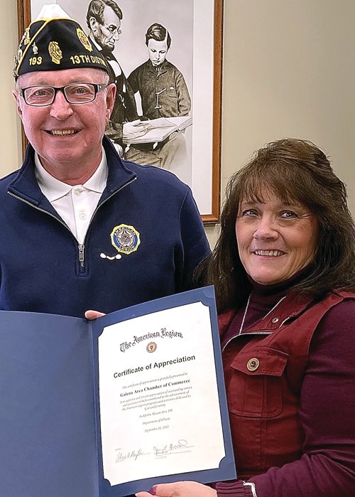 Jerry Howard, left, American Legion Fickbohm-Hissem Post 193 commander, presents Cindy Foley, Galena Area Chamber of Commerce president, a certificate of appreciation for the Chamber&rsquo;s assistance in promoting Post activities and for supporting the community this year.