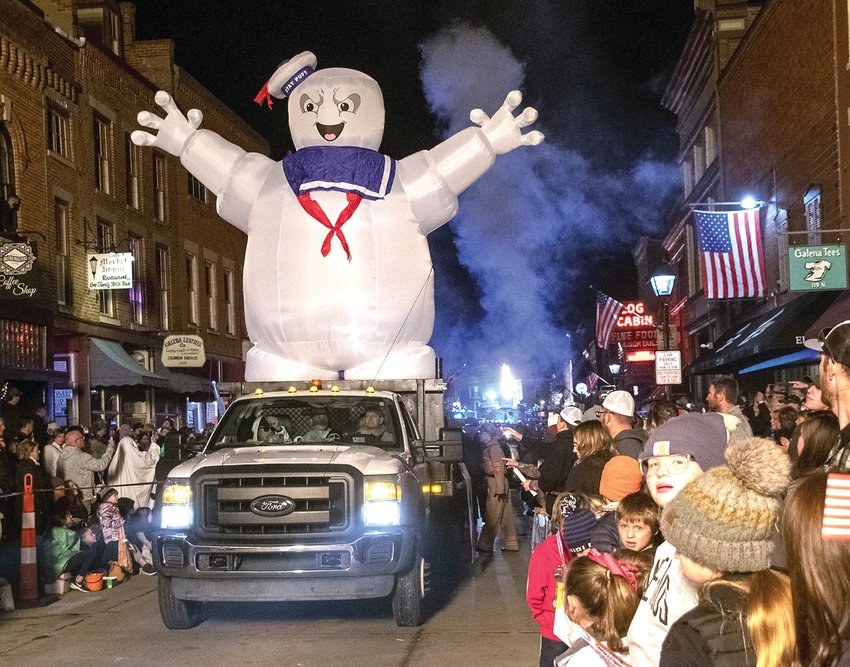 The Blaum Brothers Ghost Busters float makes its way down Main Street for the annual Galena Halloween Parade. Throngs of people lined Main Street to take in the annual event which features floats, families, businesses, politicians and numerous high school marching bands. Smoke and light from hot air balloons also lit up Main Street, giving it a magical glow. Barb Hocker, Galena Area Chamber of Commerce executive director, said there were 58 parade entries this year. She said warm temperatures helped draw a crowd of more than 25,000 people, a crowd which is believed to be larger than last year.