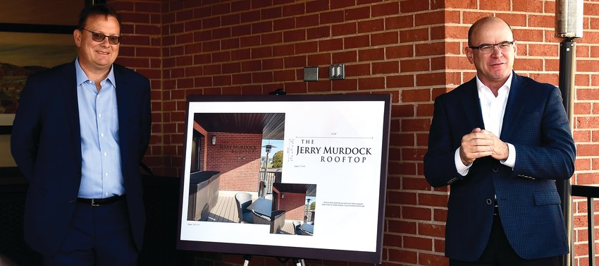 Illinois Bank and Trust dedicated their rooftop deck to former Bank President Jerry Murdock on Tuesday, Nov. 1. During the celebration, Drew Townsend, another former Bank President (left), current Bank President Joe Mattingley (right) and others shared some stories of Murdock that included topics such as his community involvement and fishing hobby. Aluminum lettering spelling out &ldquo;The Jerry Murdock Rooftop&rdquo; will be placed on the wall in about a month.