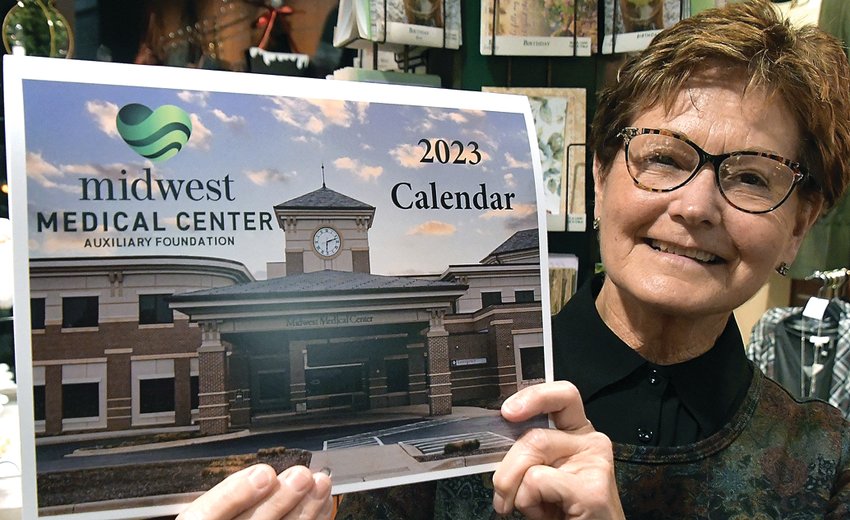 Connie Wienen, Galena, shows off the new Midwest Medical Center Auxiliary Foundation calendar for 2023
