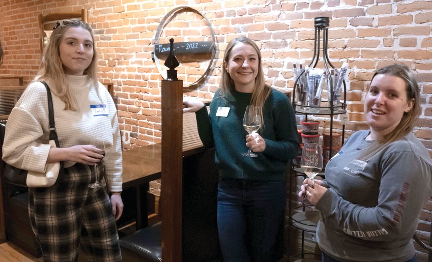 Enjoying some wine and conversation at the December Business After Hours held at Galena Cellars are, from left, Emily Tepper, Britt White and Sienna Seas.