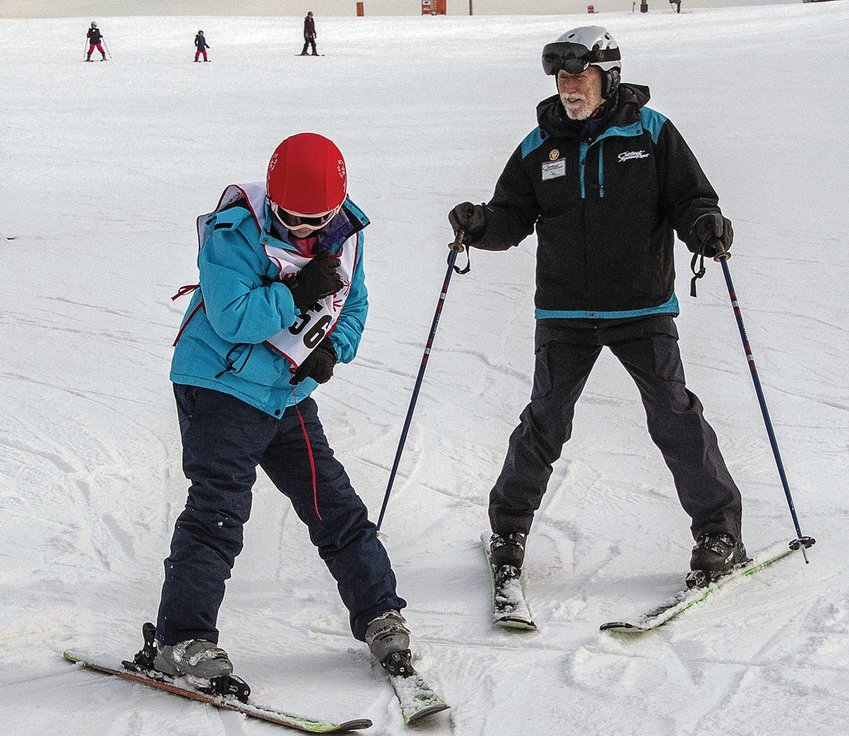 Chestnut Mountain Resort ski teacher Tom Lobacz helps a Special Olympian from the Chicago Park District on a Chestnut ski slope. Special Olympians from the park district were at Chestnut Mountain on Tuesday, Dec. 10.