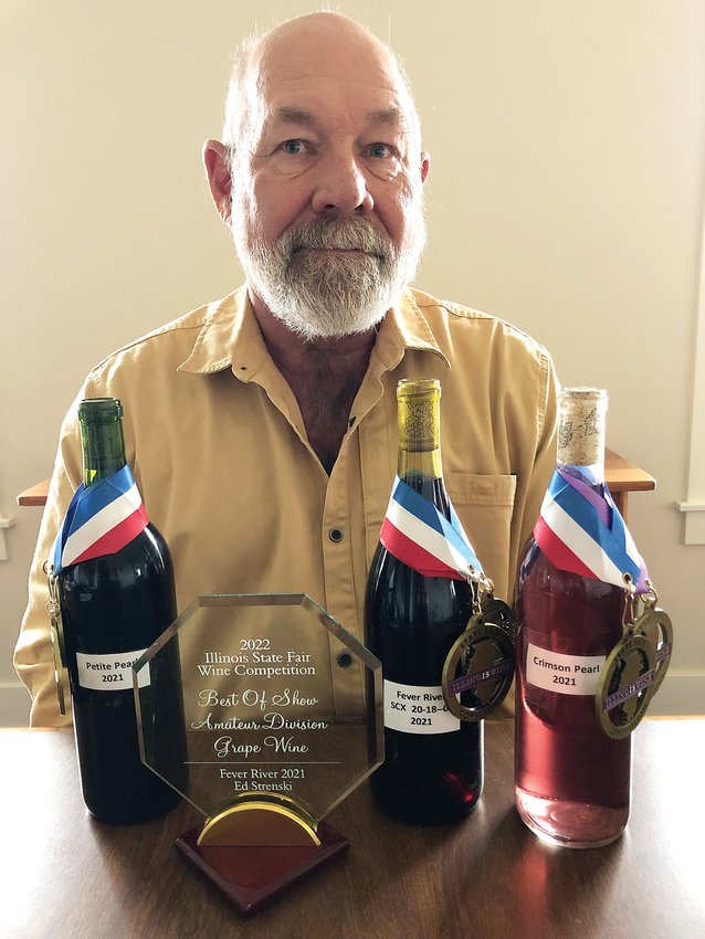Ed Strenski sits with his award-winning wines.
