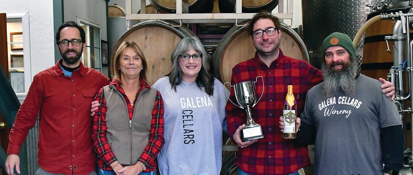 Director of the Illinois Grape Growers and Vintner Alliance Lisa Ellis presented Galena Cellars winemaker Eric White with a Governor&rsquo;s Cup for Illinois-Grown Fruit for its 2021 The Secret Garden La Crescent wine. From left: EJ Droessler, Christine Lawlor-White, Lisa Ellis, Eric White and Steve Martin.