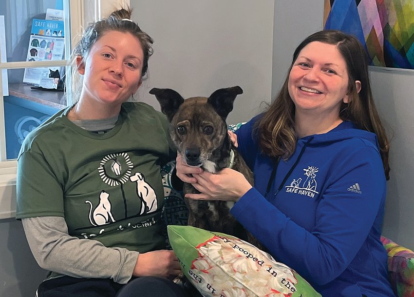 Haley Francke (left) and Jeannette Thraen (right) pose with Riff Raff, the only dog sent from Villalobos that hasn&rsquo;t been adopted yet.