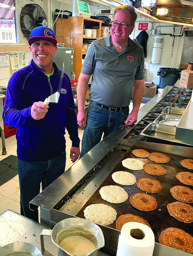 It&rsquo;s been a long time. . .two years in fact since Galena Lions Club members have occupied the Galena High School cafeteria and hosted the club&rsquo;s annual pancake breakfast and bake sale. This 2020 photo shows Phil Schuler, left, and Dan Green &ldquo;hard&rdquo; at work making the pancakes.