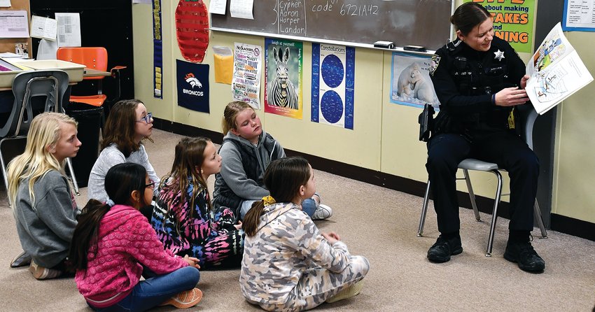 Sergeant Keith Brandel and Officer Emma Johnson visited the Galena Primary School 4th grade classes on Friday, Feb. 3 to read &ldquo;Officer Buckle and Gloria.&rdquo; Johnson read to Todd Birkholz&rsquo;s class and answered students&rsquo; questions. From left: Evelyn Miller, Amairany Garcia-Hernandez, Gretchen Sauerberg, Harper Berning, Brinley Berning, Avery Connor and Johnson.