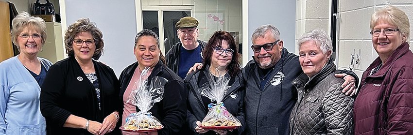 Participating in the cookie handoff at Jo Daviess County Transit are, from left, Maureen Knipschield, Kimberly Howard, Lindsey D&rsquo;Antonio, Casey Sullivan, Katie Riley, Neil Moser, Rita Wohlers and Pat Halstead.