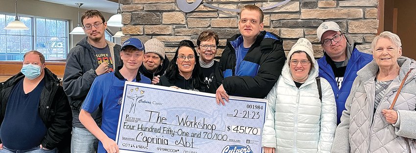 On &ldquo;Fat Tuesday,&rdquo; Tuesday, Feb. 21, Culver&rsquo;s held a Share Night for the Workshop in which $90 in cash donations were received. Participating in the check passing for $451.70 are, from left, John Asta, Daemen Swindale, Tristan Embry, Pam Brotzman, Kayla Einsweiler, Mary Doyle, Michael Dykstra, Jessica McBride, Todd McBride and Susan McBride.