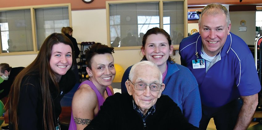 Midwest Medical Fitness Center employees (from left) Samantha Stoffregen, Natalie Gibbins, Katelyn Leiden and Marty Soat get the opportunity to work with and be around Ken Boyd (front) when he comes in to work out three times a week.