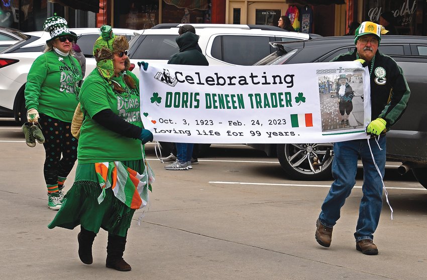 Parade walkers Wendy Meyer (back left), Jeni Pearce (front left) and Steve Meyer (right) remember Doris Trader, who passed away in February. Trader walked in the parade every year and was the oldest parade participant.