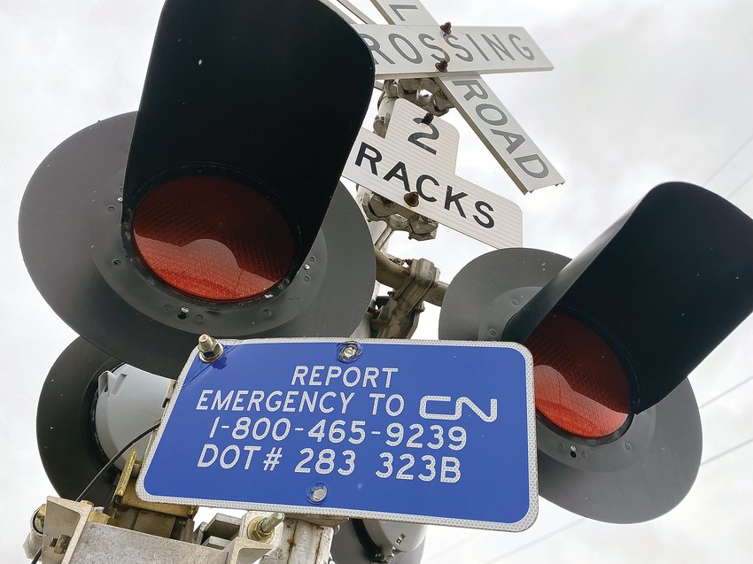 Blue signs, like this one located in South Bend, Ind., tell people what number to call in case there is an emergency on the tracks.