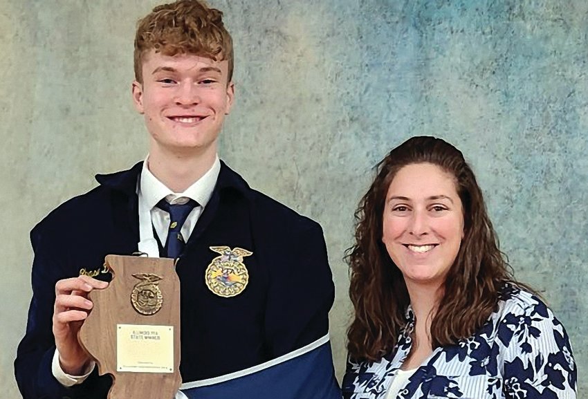 Chase Dittmar poses with the 2023 state FFA proficiency winner plaque with Galena High School&rsquo;s FFA advisor Sarah Lee.