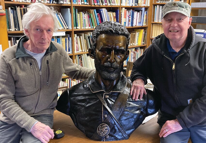 David Seagraves and Jerry Howard sit next to the new bust of Henry H. Taylor.