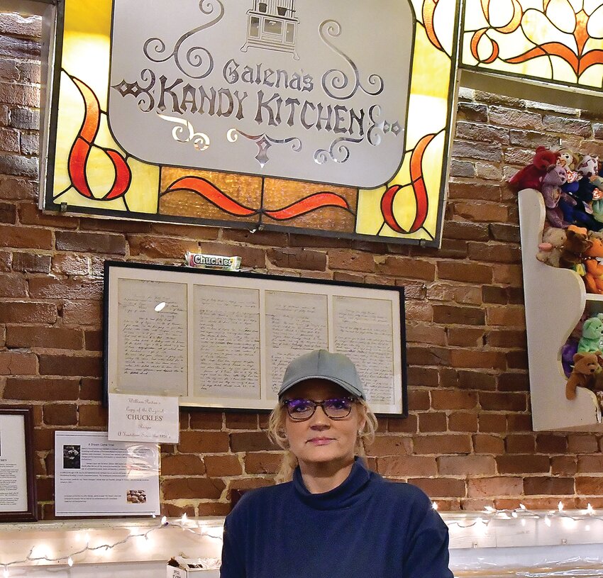 New Kandy Kitchen owner Andi Deckert poses with the iconic sign.