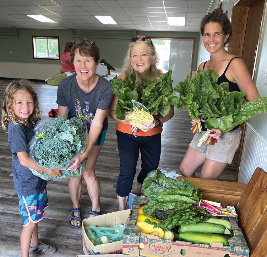 Collecting produce for the Farm to Food Pantry program. From left to right:  Huxley Mond, Jen Nottrott (producer from Tower View Farm), Lynda Birkel (volunteer), Darcee Mond (producer from Galena River Ranch).