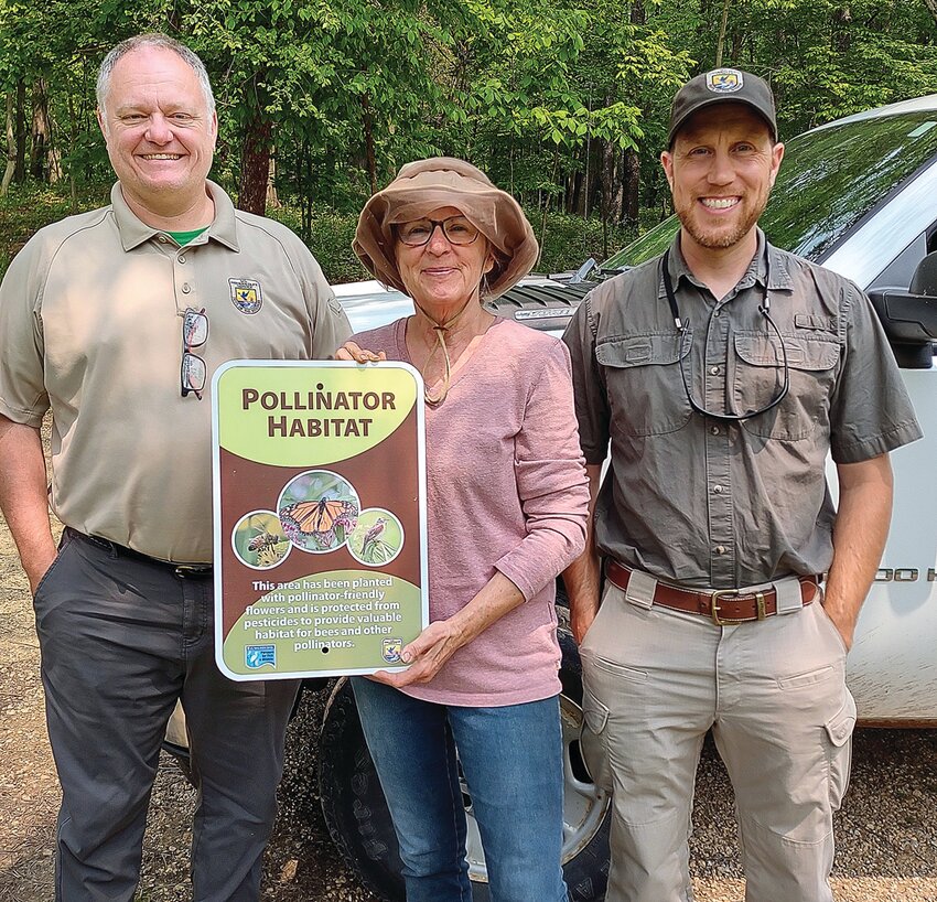 From left to right: Mike Redmer (FWL), Valerie Slayton (landowner), and Scott James (FWL) present the signage for work on land that has been planted in pollinator-friendly seed provided by the United States Fish and Wildlife Services. The FWL personal are dedicated to management of fish and wildlife resources from national wildlife refuges, invasive species management and law enforcement through protection laws. For more information visit fws.gov.