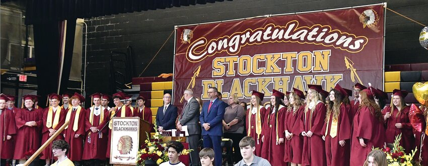 The Stockton Blackhawks class of 2023 senior graduates stands after the processional of the high school graduation ceremony on Sunday, May 21.
