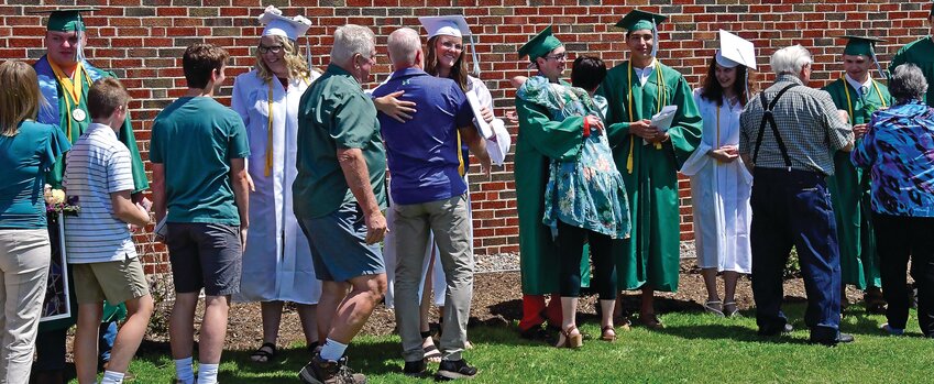 Scales Mound students formed a line outside the school after graduation, so attendees could offer their congratulations.