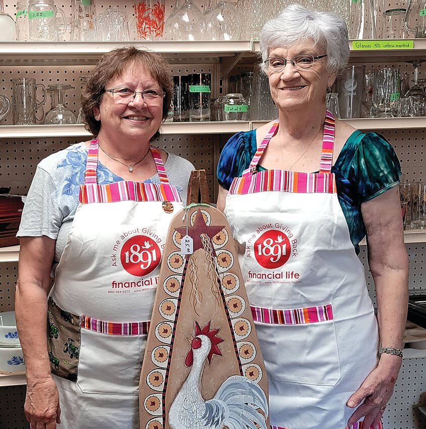 From left, Karen Reese (treasurer) and Sylvia Wentz (president) of Holy Ghost Court 228 in Dickeyville, Wis., represent the recently-held bake and garage sale at the Holy Ghost church basement during the four-day Memorial Day weekend through the &ldquo;Hearts &amp; Hands&rdquo; program. It was sponsored by 1891 Financial Life (formerly known as National Catholic Society of Foresters) for the purpose of purchasing a new granite covering on the grave of the builder of the Grotto, Rev. Matthias Wernerus, in front of his tombstone. Net proceeds total $6005 with a matching fund check of $1500 from 1891 Financial Life.