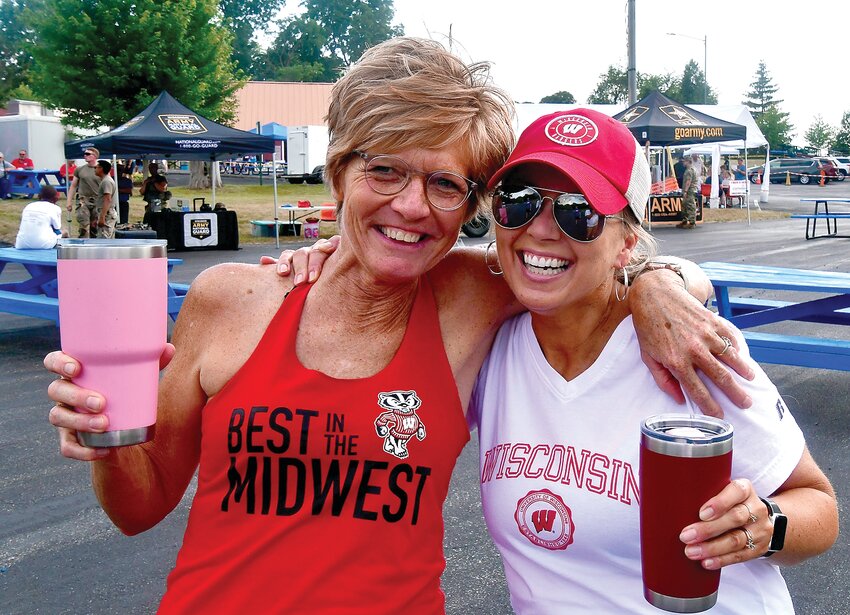 Neighbors Diane Pearce, left, and Tracy Behlke, right, celebrate community at Hazel Green&rsquo;s Tunes and Booms.