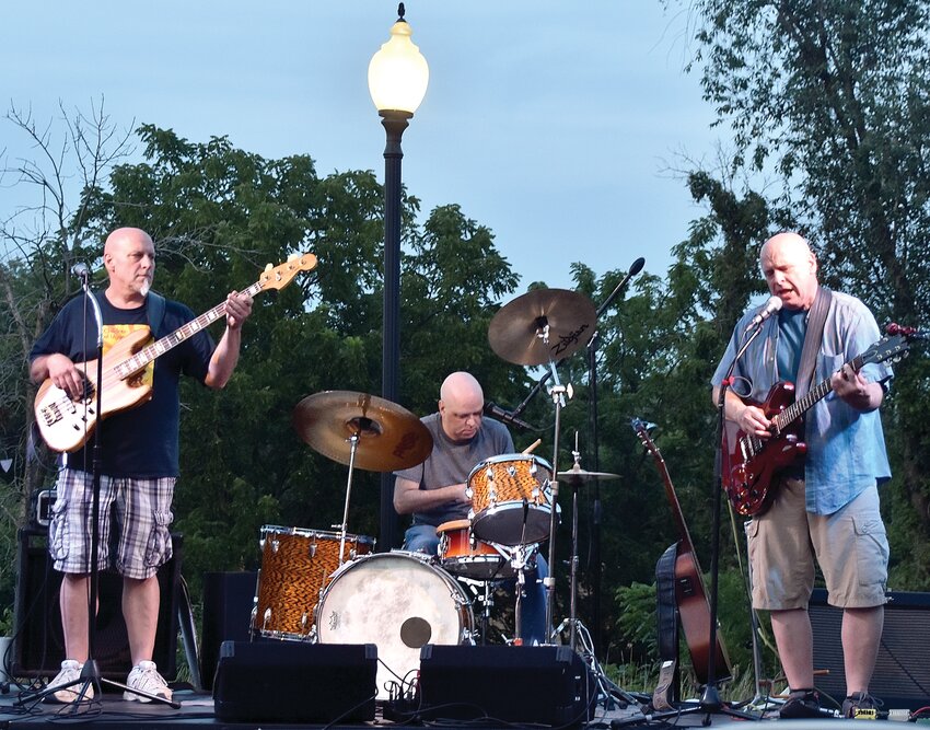 The Matz Brothers performed their original rock music at the Galena Center for the Arts Songwriters Showcase on Thursday, Aug. 10. They are Rob Matz, left; David Matz, drums; and Rich Matz, lead guitar. This night also happened to be drummer David Matz&rsquo;s birthday.