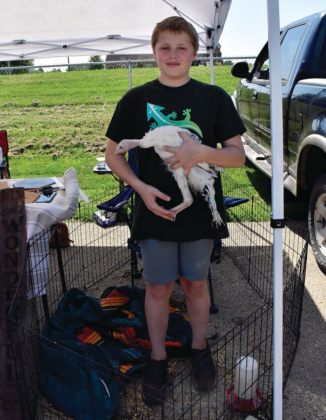Farmers, food vendors and artists had booths where they sold their merchandise at the Elizabeth Harvest Fest. Hayden Bradbury let passersby pet Princess, a turkey from Driftless Gobblers.