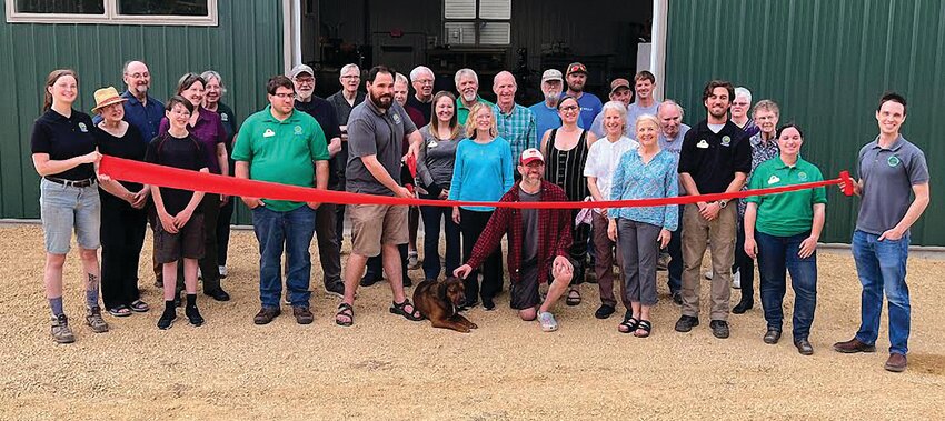 A group of contractors, friends, and neighbors joined JDCF staff and board for a ribbon cutting at the new shop last May.