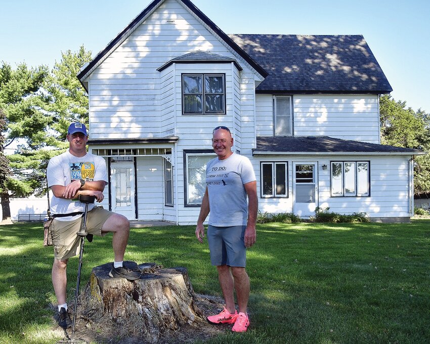 The Driftless Digger, Jim Winter, and property owner Brian Christ pose in front of his family&rsquo;s mid-1800s farm house.