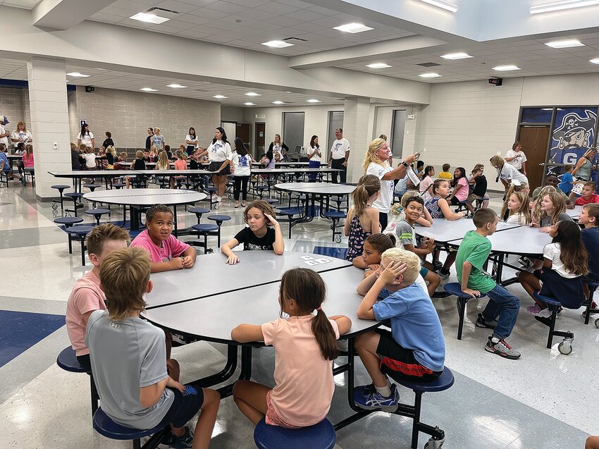 Students wait in the remodeled cafeteria in the new Galena Elementary and Middle School.