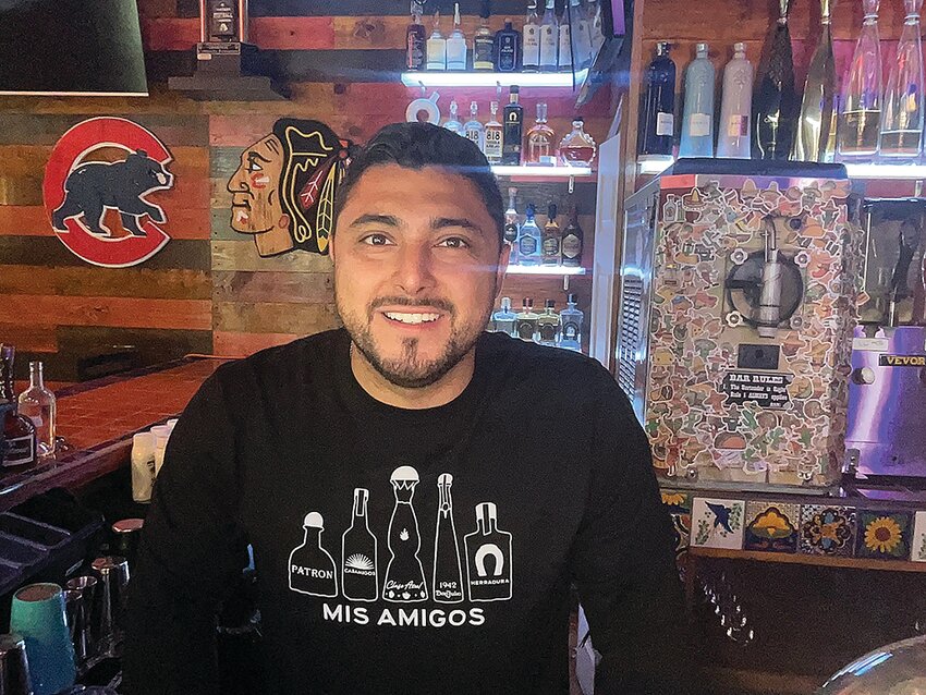 Owner of Campeche&rsquo;s, Eric Lopez, poses behind the bar.