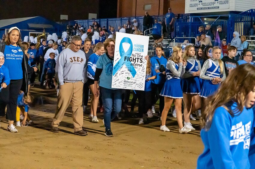 Brianne Van Hemert, Steve and Janelle Keeffer led over 100 students , faculty,  Midwest Medical Center staff and Galena Pirate football fans on their walk around the track to promote awareness of prostate cancer. Many of those participating were also  survivors of prostate cancer.