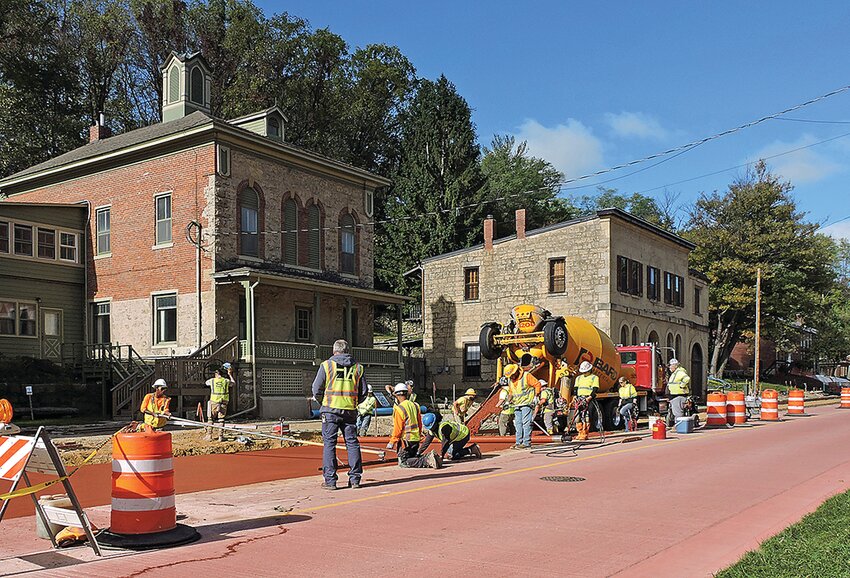 On Monday. Oct 16 the Spring St. road construction made progress. Above: The paving crew extends the pavement past the old Speier Brewery buildings.