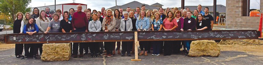 Those affiliated with Midwest Medical Center, including staff and board members, signed a beam that will be put up in the hospital.